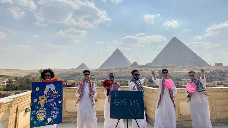 Egyptian team with a personalized greeting board at the Pyramids
